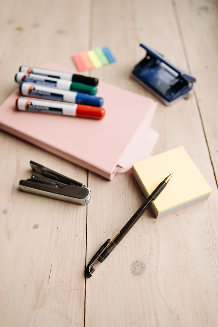 services-hero Flat lay of office supplies like markers, pen, stapler on a wooden desk, perfect for workspace themes.